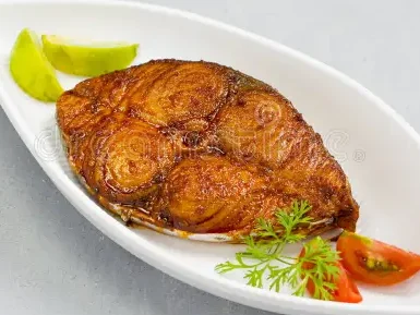 seer fish fry arranged beautifully garnished onion lemon tomato slices white ceramic plate grey textured background 214260835 e1759225243394